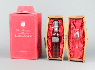 A limited edition 23cl bottle of Bas Armagnac De Chateau De Lacaze Heritage contained in a presentation barrel together with a glass