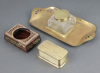 A 19th Century ribbed brass tinder or match box with hinged lid 3cm x 8cm x 4cm, a rectangular Art Nouveau pierced brass and glass inkwell/standish 5cm x 21cm x 10cm together with a red boulle and brass inkwell 3cm x 8cm x 5cm 
