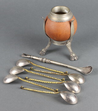 A gourd mounted on a white metal stand together with an Alpaca Eberle gourd strainer and 6 gilt metal spoons 