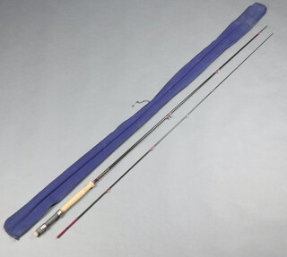A Bruce Walker 10', 2 piece reservoir fishing rod with 8 line weight contained in a blue cloth bag 