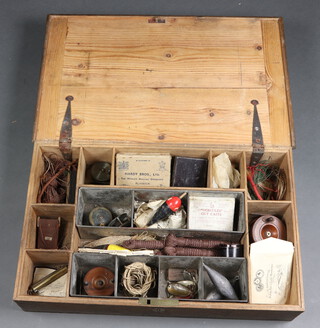 A Victorian rectangular pine fishing box with hinged lid, the interior fitted 2 aluminium trays containing three 5" brass fishing reels, a mahogany star back reel 3 1/2", together with lures, flies, lines etc 