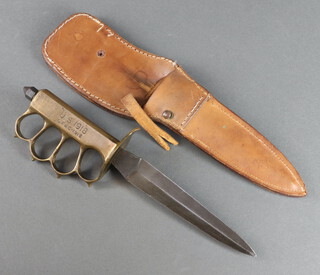 A First World War American knuckle duster trench knife, the brass grip marked US 1918, LF & C 1918,  having a 17.5cm blade (nick to point of blade) contained in a leather scabbard