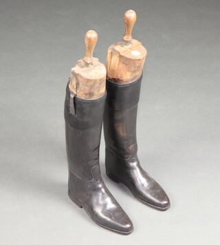 A pair of black riding boots with beech trees by Tom Hill of Knightsbridge 