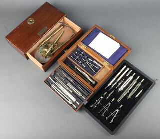 A War Office set of drawing instruments contained in a black leather finished case marked W10/VC/5841 with broad arrow LG 1954, set of geometry instruments contained in a mahogany case together with a Johnson & Hendon brass and mahogany scales 