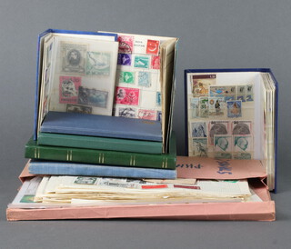 A Stanley Gibbons album of world stamps - British Possessions Victoria and later, America, a Blue Lagoon album of world stamps - Italy, GB, etc, a small blue stock book of Victorian and later GB stamps, 4 ther stock books of stamps and a pink file containing loose stamps on paper and sheets 