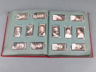 A red album of Wills, Ogdens and Players cigarette cards