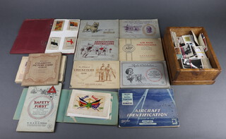 Six albums of Wills cigarette cards - Radio Celebrities, The Reign of George V, Safety First, Dogs, Association Football 1935-1936 Air Raid Precautions together with a small box of loose cigarette cards and an album of coloured postcards