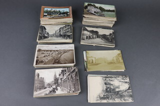 A collection of black and white and coloured postcards 