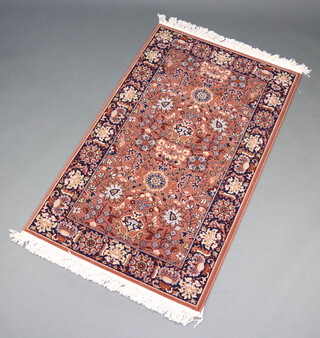 A tan and black ground Persian style machine made rug 152cm x 91cm 
