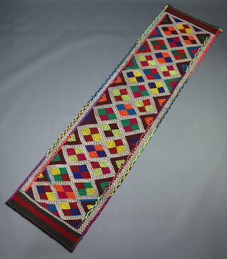 A blue, orange, white and red ground Suzni kilim runner with all over geometric design, 270cm x 67cm 