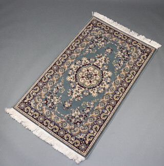 A blue and white ground Persian style machine made rug 150cm x 91cm 