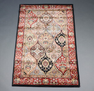 A black, tan and gold ground Persian style machine made rug 167cm x 107cm 
