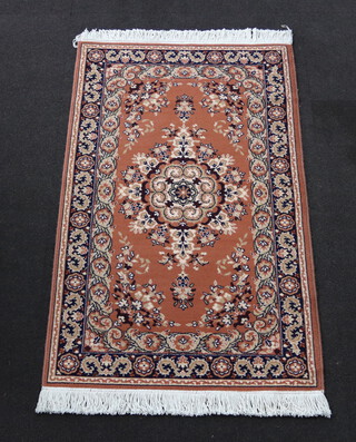A brown and black ground machine made Persian style rug with central medallion 90cm x 150cm 