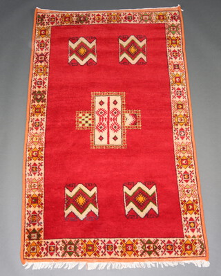 Am orange and red ground Afghan rug with rectangular medallion to the centre within a single row border 191cm x 118cm 