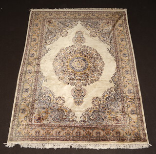 A cream and brown ground Persian rug with central medallion within a multi row border 281cm x 212cm 