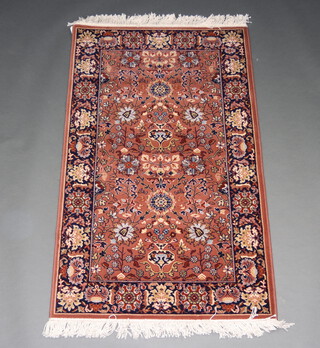 A blue and brown ground Persian style machine made rug 149cm x 90cm 