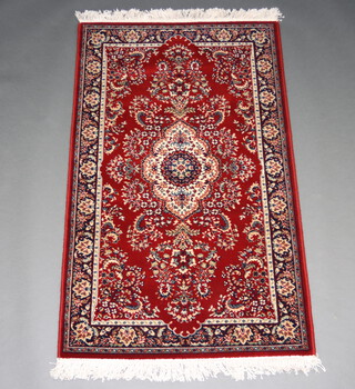 A red and white ground machine made Persian style rug with central medallion 155cm x 91cm 