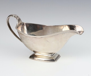 An Art Deco silver sauce boat with scroll handle Birmingham 1930 148 grams 