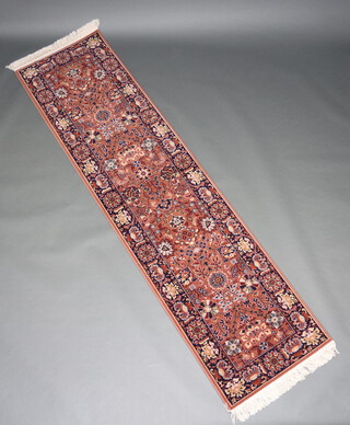 A brown and blue ground Persian style machine made runner 271cm x 71cm 