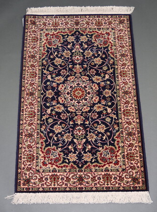 A blue and white ground floral pattern Persian style machine made rug with medallion 148cm x 92cm 