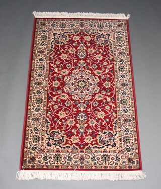 A red and white ground Persian style machine made rug with central medallion 153cm x 92cm 