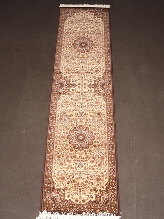 A brown and white ground machine made Persian style runner with 2 medallions to the centre 348cm x 89cm 