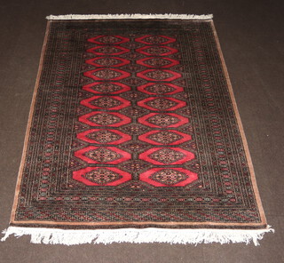 A pink and grey ground Bokhara rug with 29 stylised diamonds to the centre within a multi row border 224cm x 160cm 