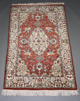 A brown and white ground Kashmir rug with central medallion decorated horseman and animals 183cm x 120cm 