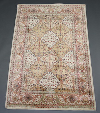 A gold ground Persian style machine made rug with all over geometric design 180cm x 120cm 