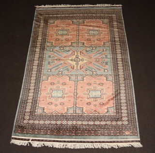 A grey and pink ground Bokhara rug with 5 stylised medallions to the centre within a multi row border 280cm x 187cm 