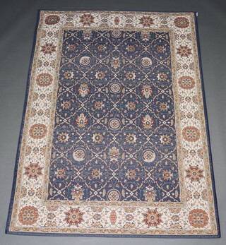 A blue and white ground Persian style machine made rug 215cm x 153cm 