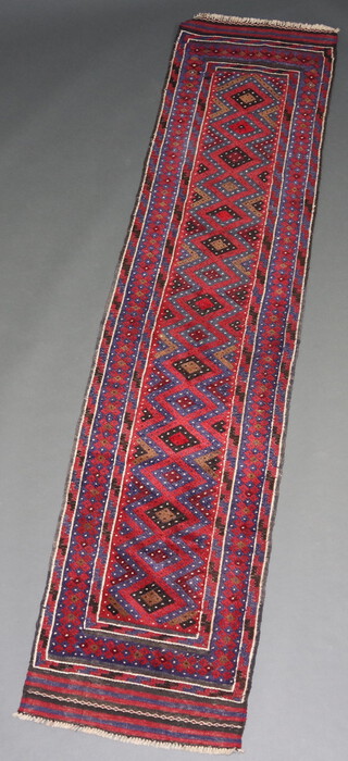 A red, white and blue ground Meshwani runner with 16 diamonds to the centre 174cm x 66cm 