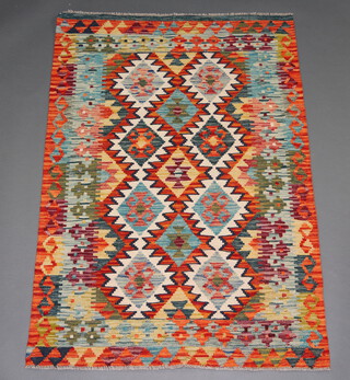 A blue, green, orange and yellow ground Chobi Kilim rug with all over geometric designs 152cm x 104cm 