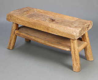 A hardwood Naga rice pounding table table with undertier raised on outswept supports 48cm h x 97cm w x 36cm d 