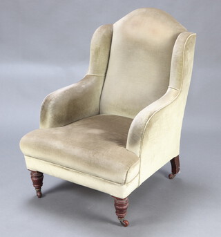 A Victorian armchair upholstered in green material, on turned supports 194cm h x 72cm w x 71cm d  