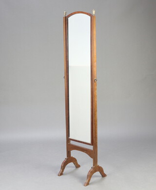 A 1930's arched plate cheval mirror contained in a mahogany swing frame with brass finials, 161cm h x 38cm w x 31cm d 