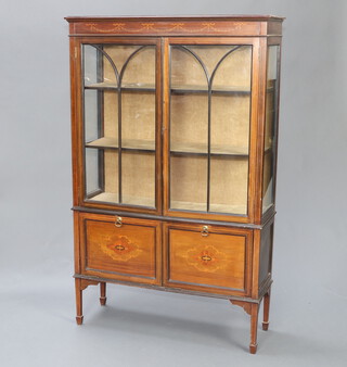 An Edwardian inlaid mahogany display cabinet with moulded cornice, fitted shelves enclosed by astragal glazed panelled doors, the base with 2 fall fronts and fitted for sheet music, raised on square supports, spade feet 64cm h x 103cm w x 33cm d