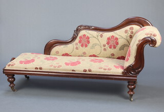 A Victorian mahogany show frame chaise longue upholstered in floral patterned material raised on turned supports 86cm h x 168cm l x 53cm d (seat 138cm x 45cm) 