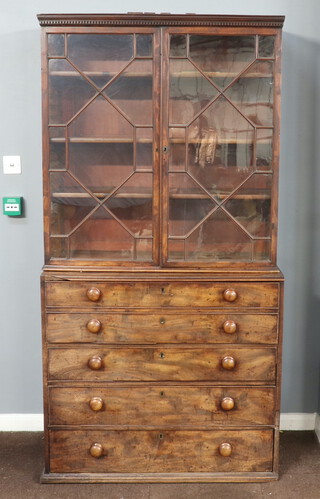 A Georgian mahogany secretaire, the upper section with moulded and dentil cornice, fitted shelves enclosed by astragal glazed panelled doors, the base fitted a secretaire drawer above 3 long drawers 209cm h x 107cm w x 57cm d 