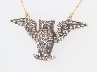 A yellow metal diamond and ruby set owl pendant 42mm on am 18ct yellow chain (a/f), 7 grams 