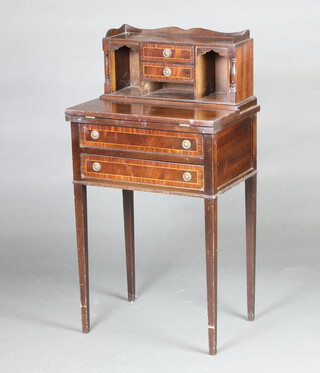 A Georgian style inlaid mahogany writing table having a raised super structure with 3/4 gallery, fitted 2 short drawers and 3 pigeon holes, the flip over top base fitted 2 drawers, raised on square tapered supports 100cm h x 53cm w x 39cm d (water and contact marks) 