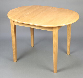 A light elm oval extending dining table with concealed extra leaf, raised on square tapered supports 74cm h x 107cm l x 80cm w (scratch to top) 