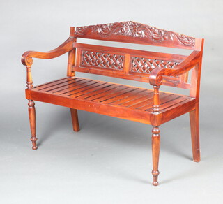 A Georgian style carved and slatted hardwood bench, raised on turned supports 96cm h x 120cm w x 56cm d (seat 100cm x 37cm, cresting rail is sun bleached) 