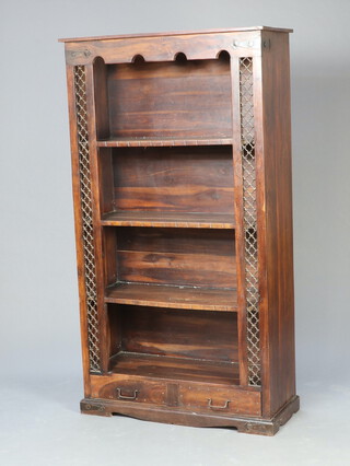 An Eastern hardwood bookcase with iron grill decoration to the sides 180cm h x 101cm w x 40cm d 
