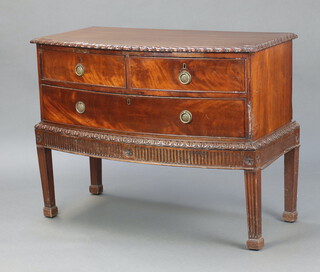 A Chippendale style mahogany bow front chest on stand fitted 2 short and 1 long drawers, raised on square fluted supports 81cm h x 104cm w x 53cm d (top is warped, split and has contact marks) 