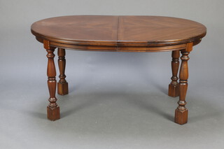 An oval oak extending dining table raised on turned supports 76cm h x 148cm l x 105cm w