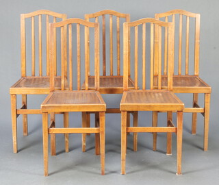 A set of 5 1930's Continental beech stick and rail back dining chairs with solid seats, raised on square tapered supports 96cm h x 40cm w x 40cm d (Contact marks, 3 stretchers have dog gnawing)  
