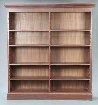 A Georgian style Eastern hardwood bookcase with moulded cornice fitted 12 adjustable shelves, raised on a platform base 196cm h x 179cm w x 34cm d 
