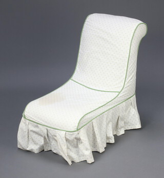 A Victorian nursing chair upholstered in light coloured material, with a green and white loose cover, raised on turned supports 63cm h x 64cm w x 36cm d 