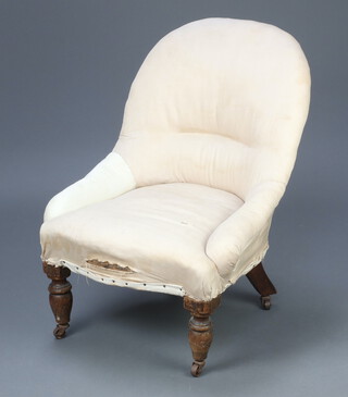 A Victorian metal framed nursing chair upholstered in white material raised on turned supports 70cm h x 55cm w x 43cm d 
